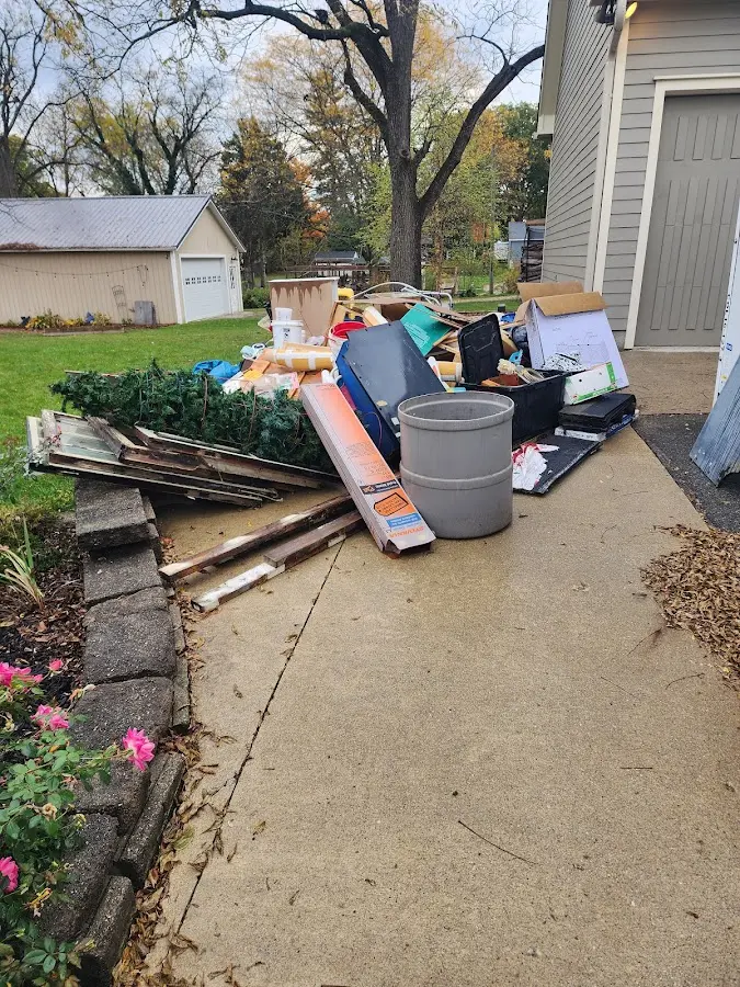 Dumpster being loaded with debris for 10 Yard Dumpster Rental in Morris Plains